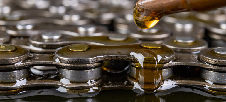 Lubricant being applied to an industrial chain