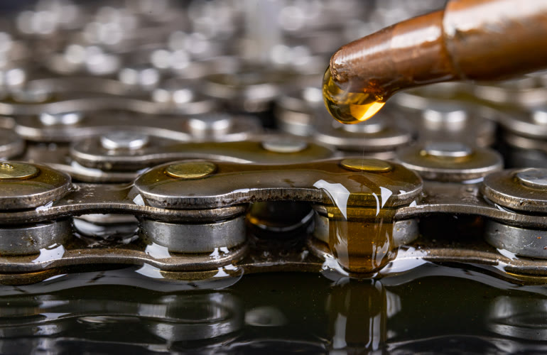 Lubricant being applied to an industrial chain